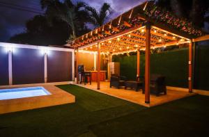 a patio with a pergola with a table and chairs at Deluxe beach house in Westfalia
