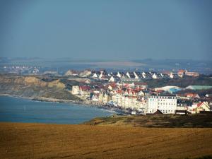 a group of buildings on a hill next to the ocean at Mer&Campagne Wimille in Wimille