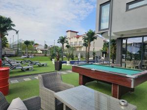 a pool table in the backyard of a house at Grand Bahia Relaxury in Costinesti