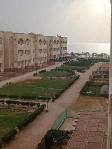 a view of a building with the ocean in the background at Blue lagoon resort in Ras Sedr
