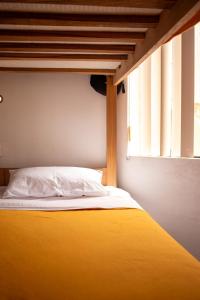 Ένα ή περισσότερα κρεβάτια σε δωμάτιο στο Temazcal Hostel