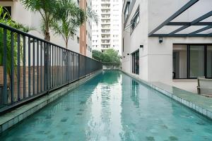 a swimming pool in the middle of a building at Occa Stay Cobogó - A115 in Sao Paulo