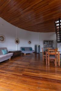 a large living room with a table and a couch at Cinco Elementos in El Peñol