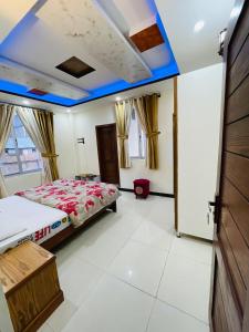 a bedroom with a bed and a blue ceiling at Paradise View Hotel & Restaurant in Khaira Gali
