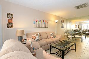 a living room with a couch and a table at Biarritz Mirage - 1BR Downtown Condo in Palm Springs