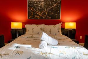 a bedroom with a white bed with two lamps at Majestic Mansion with Bar and Entertainment Space in Mississauga