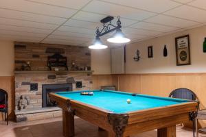 a pool table in a living room with a fireplace at Majestic Mansion with Bar and Entertainment Space in Mississauga