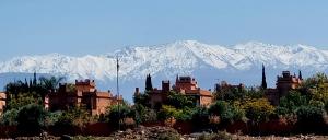 a building with mountains in the background in front at VILLA Garden in Marrakesh