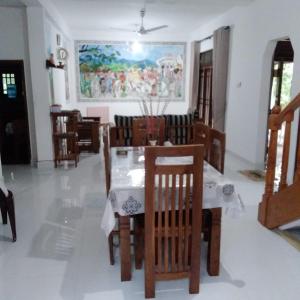 a dining room with a table and chairs at Sanduhan Villa in Warakapola +22 photos