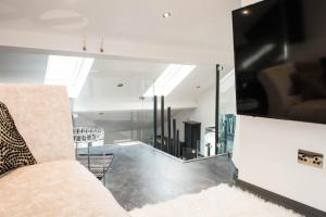 a living room with a couch and a large mirror at The Penthouse in Kendal
