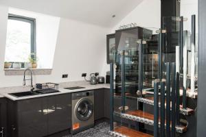a kitchen with a washer and dryer at The Penthouse in Kendal +19 photos