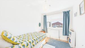 a bedroom with a bed and a window at Sea Breeze in Brading