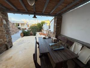 a wooden table and chairs on a patio at Nefeli in Livadi