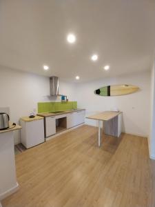 a kitchen with a surfboard hanging on the wall at Dezassete - Ericeira in Ericeira