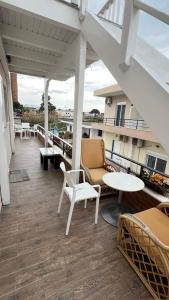 a balcony with chairs and tables on a building at Apartments by Arbri 2 in Vlorë