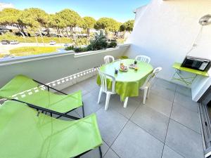 a small balcony with a table and chairs on it at Les Petits Bateaux-Parking privé-Terrasse in La Grande-Motte +22 photos