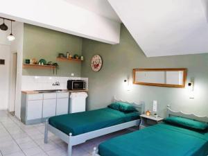 a bedroom with two beds and a sink in it at Valentino Studio Kalymnos in Kalymnos