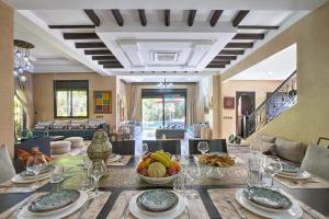 a dining room with a table with a bowl of fruit at VILLA Garden in Marrakesh