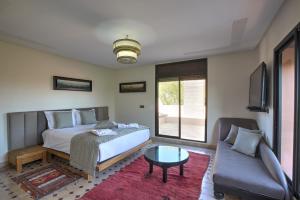 a bedroom with a bed and a couch at VILLA Garden in Marrakesh