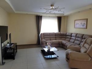 a living room with a couch and a table at Vaido apartamentai in Marijampolė