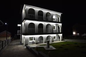 a lit up building at night with a building at VILA RUŽA - Grand apartman 2 in Soko Banja