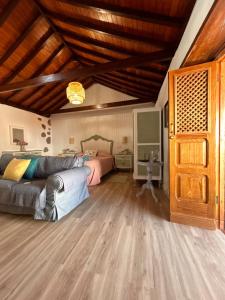 a bedroom with a bed and a couch at Balcón Néstor Álamo II in Tejeda