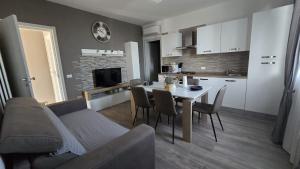 a kitchen and living room with a table and a couch at B&B Marta CARPINELLO in Carpinello