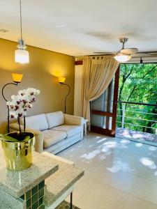 a living room with a couch and a table at Chalé Banho de Floresta Atibaia Clube de Montanha in Atibaia