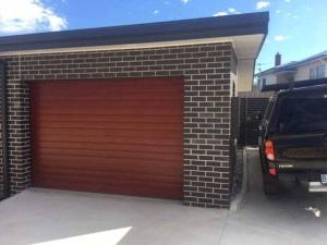 a garage with a car parked in front of it at The Villa at 165 Contemporary apartment in Warrane