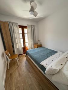a bedroom with a bed and a chair and a window at Casa Limon in Cartagena +30 photos