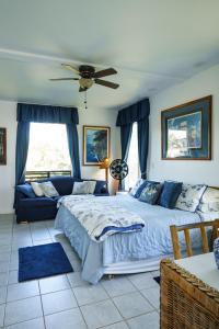 a bedroom with a large bed and a couch at Lanai Villas in Koloa +19 photos