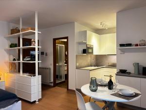 a kitchen with a table and chairs in a room at Riva&Lago Gravedona - Larihome A90 in Gravedona