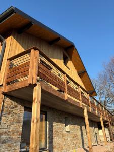 a wooden deck on the side of a building at Chalet Cimebleu SPA & Sauna in Basse-sur-le-Rupt