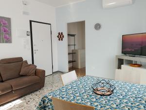 a living room with a couch and a table at Sun House in Montesilvano