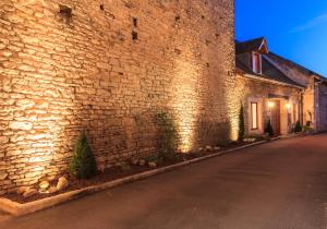 a brick building with a street in front of it at Hotel De La Cloche in Beaune