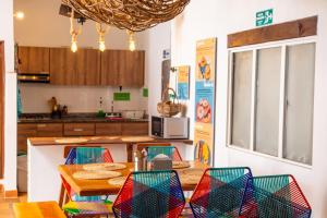 a kitchen with a table and chairs in a kitchen at Traveler Hostel in San Gil