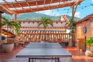 a table on the patio of a house at Traveler Hostel in San Gil