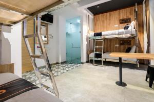 a room with two bunk beds and a desk at Collection O 2627 Ratamya Co-living in Yogyakarta
