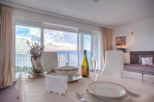 a dining room with a table with a view at Apartments Villa Manda in Novi Vinodolski