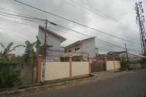 a house on the side of a street with a fence at Hotel O Wisma Bunda Syariah Near Man Pinrang in Salo +16 photos