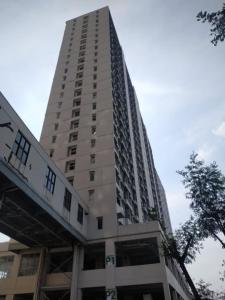a tall white building with a walkway in front of it at OYO Life 92745 The Margo Monthly Stay in Depok