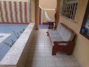 a bench sitting on a tiled floor in a room at Pousada Acácia da Barra in Salvador