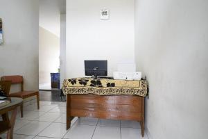 a room with a desk with a television on it at OYO Life 2874 Berlian Residence in Palembang