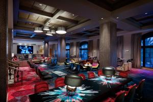 a hotel lobby with tables and chairs and a bar at Universal's Hard Rock Hotel® in Orlando