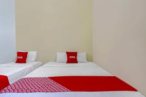 Postel nebo postele na pokoji v ubytování Super OYO 92437 Wahidin Guesthouse