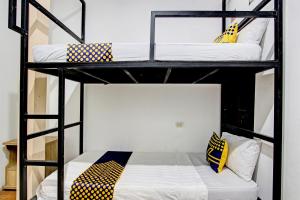 two bunk beds in a room with a bed at Hotel O Cindelaras B&b Bunk Bed in Piyungan