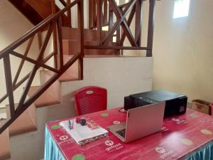 a table with a laptop and a printer on it at Hotel O Lourdes Blessing Hill in Tomohon