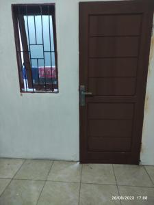 an open door in a room with a window at Hotel O Lina Homestay Syariah in Sedati +16 photos