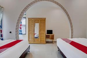 Postel nebo postele na pokoji v ubytování OYO 92211 Timur Raya Homestay Syariah