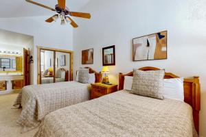 a bedroom with two beds and a ceiling fan at Big Views at Red Pine in Park City +22 photos